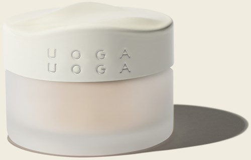 A white jar with embossed letters spelling "UOGA" on its side, casting a shadow on a white background.