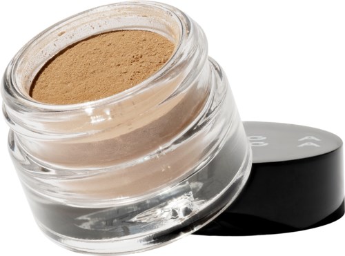 En liten glasburk med beige puder och svart lock bredvid.