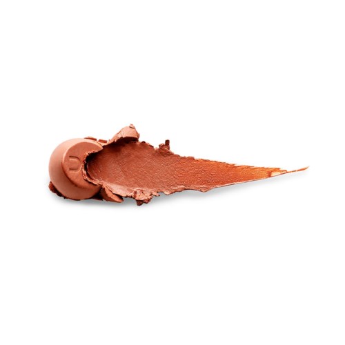 A swatch of brownish-orange cream or makeup with a brush mark on a white background.