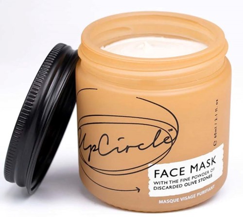 A beige jar with a black lid, labeled 'Face Mask' with white and black text, containing a white creamy substance.
