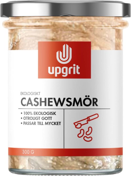Laseja ekologista cashew-voita, hopeanvärinen kansi, punainen ja valkoinen etiketti, jonka näytössä Upgrit ja tuotetiedot.