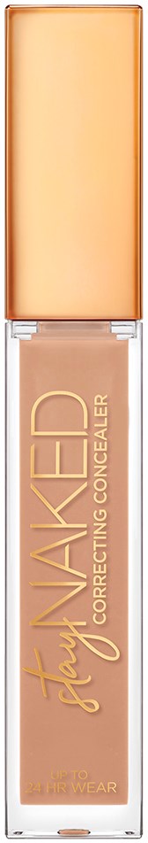 En beige flydende concealer i gennemsigtig tube med guldhætte, mærket "Stay NAKED."
