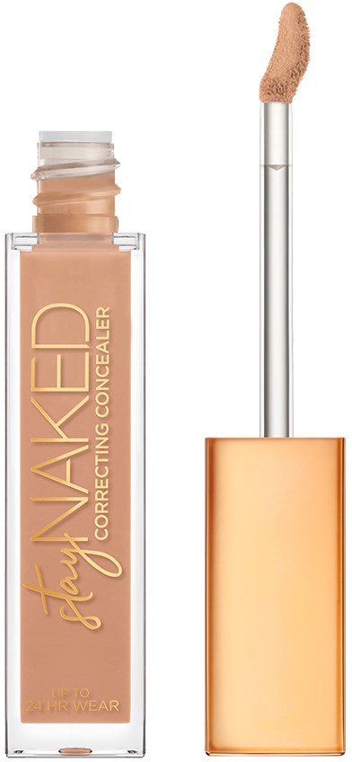 En concealer-flaske med svampeapplikator og guldhylster, mærket 'Stay Naked Correcting Concealer.'