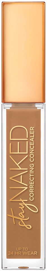 En lang, gennemsigtig flaske med beige væske og en ferskenfarvet hætte, mærket 'Stay Naked Correcting Concealer'.