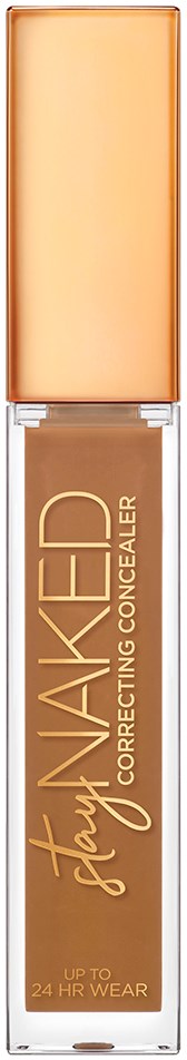 En beige flydende concealer i en gennemsigtig tube med en ferskenfarvet låg, mærket 'Stay NAKED Correcting Concealer.'