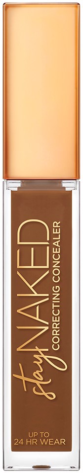 En makeup-concealer med beige låg og klar krop, der viser produktet indeni. Det står 'Naked Stays' og 'Correcting Concealer.'