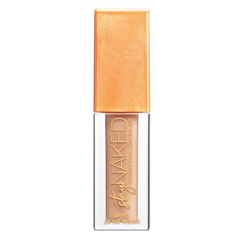 En flydende concealer i gennemsigtig tube med guldskrift og guldlåg.