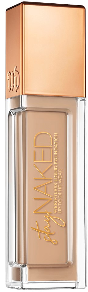 En foundationflaska med roséguldig lock och beige vätska inuti. Varumärket 'Stay WAKED' står på flaskan.