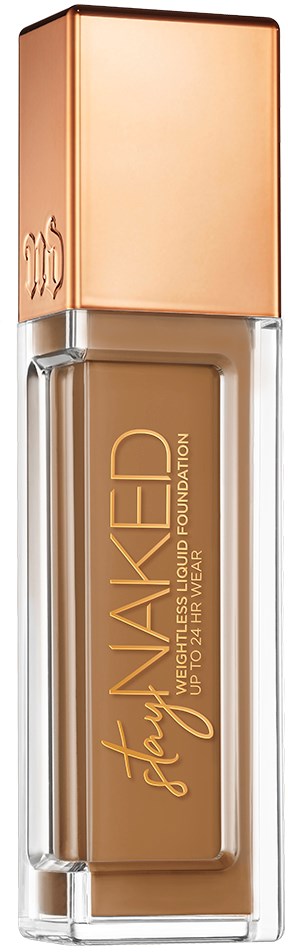 En flaska flytande foundation med beige färg och roseguldkapsel. Flaskan har orden "Stay Naked" och "Liquid Foundation" skrivet på den.