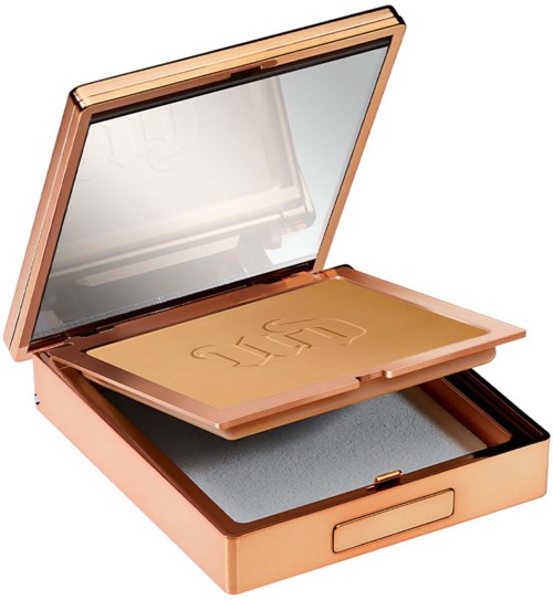 A rose gold makeup compact with a mirror inside. Contains pressed powder or blush. Elegant and shiny design.