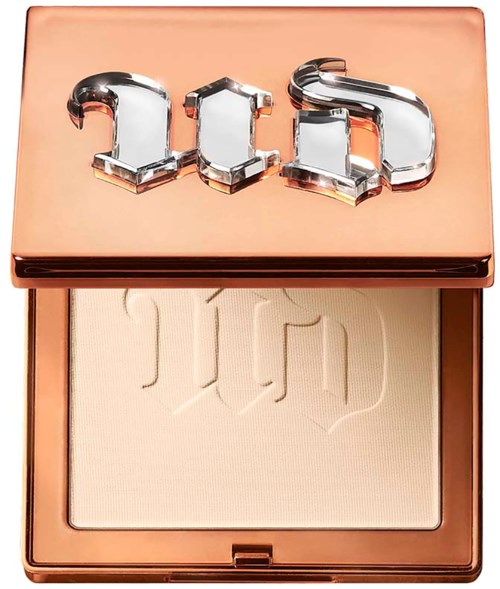 A makeup compact with a shiny rose gold case, the word 'GHD' engraved on the powder.