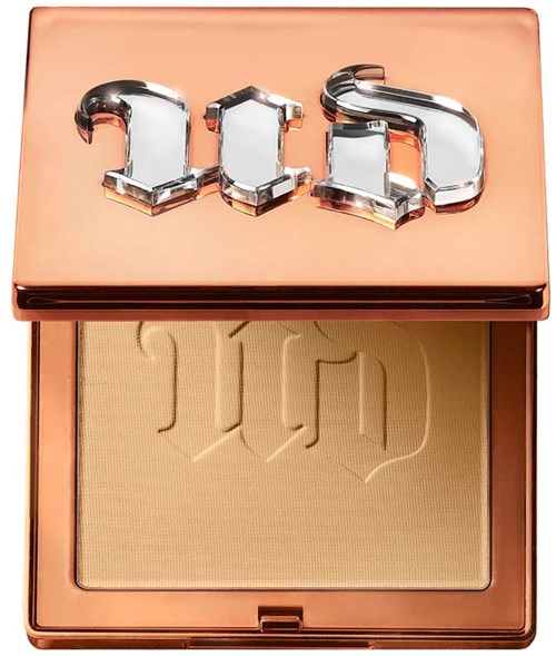 A makeup powder container with a shiny pinkish lid and a logo that says 'fenty'.