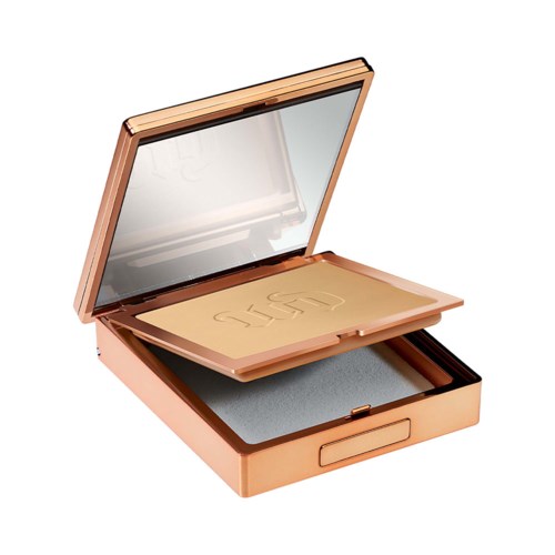 A compact, rose gold makeup palette with a mirror inside, containing foundation and a sponge applicator.