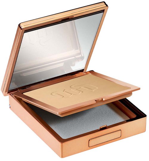 A makeup or cosmetic case with a mirror and a powder container inside in a rose gold color.