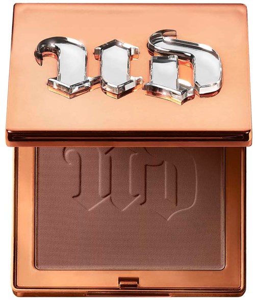 A makeup compact with a shiny rose gold lid and engraved powder inside, featuring the "Too Faced" logo in chrome letters.