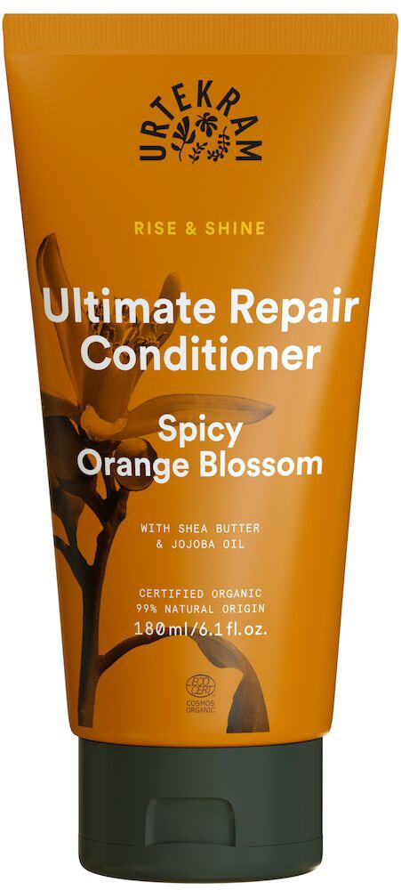 Oransje tube med balsam med krydret duft, inneholder sheasmør og jojobaolje, for hårreparasjon og glans.