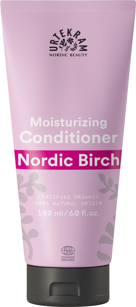 En rosa tub med fuktgivande balsam med svart lock, märkt 'Nordic Birch' av Dr. Teeram, med några blad på.