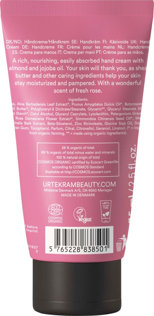 En rosa tub handkräm med ingredienser, instruktioner och vegansk märkning synlig på baksidan.