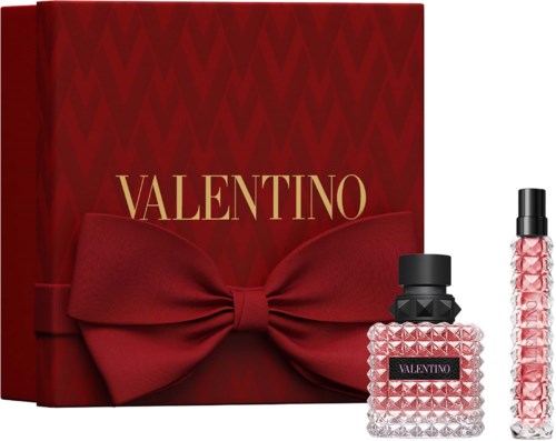 Valentino perfume gift set includes a patterned glass bottle, smaller spray bottle, and a large red box with a bow.