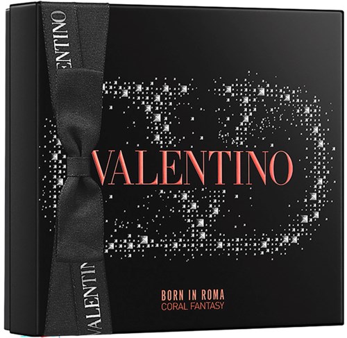 A black box with a Valentino logo and a black ribbon, decorated with white sparkles and text about the brand.