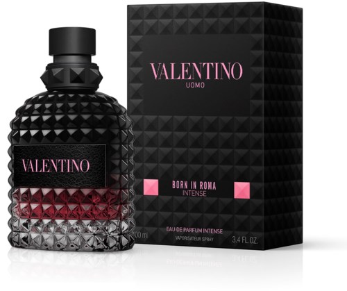 A black perfume bottle with a textured diamond pattern and a pink label, next to a black box with pink accents.