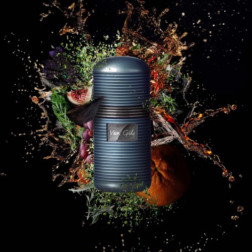 A metallic thermos surrounded by colorful fruit and splash effects on black background.