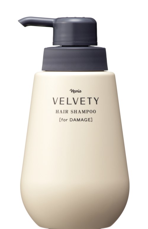 Een beige fles Velvety haarshampoo voor beschadigd haar met een grijze pomp.