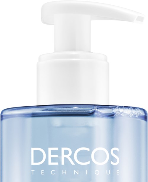 A clear blue liquid in a pump bottle labeled 'Dercos Technique'.