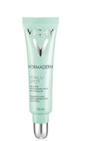 En ljusgrön tub med silverlock, märkt "Vichy Normaderm Hyalu Spot," för hudvård. 15 ml.