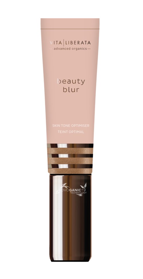 En rosa tub av Vita Liberata hudtonoptimerare med en brun och guldbeströdd hatt.