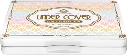 A white rectangular makeup product box with colorful feather-like patterns and gold and black decorative elements.