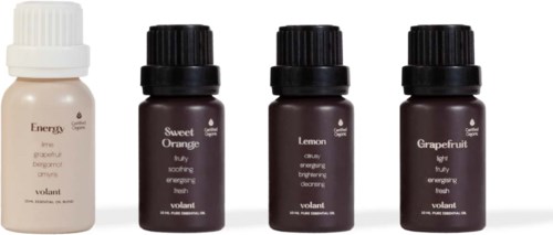 Four small bottles of essential oils labeled Energy, Sweet Orange, Lemon, and Grapefruit, arranged in a line.