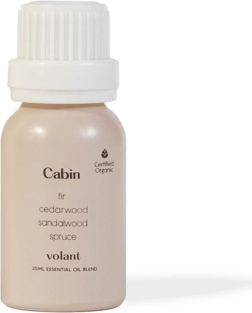 A small bottle of essential oil labeled 'Cabin' with a white cap. Describes cedarwood, sandalwood, and spruce scent blend.