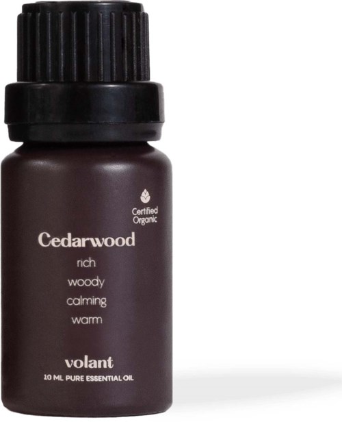 A small, dark brown bottle of cedarwood essential oil with a black cap, labeled 'Volant'.