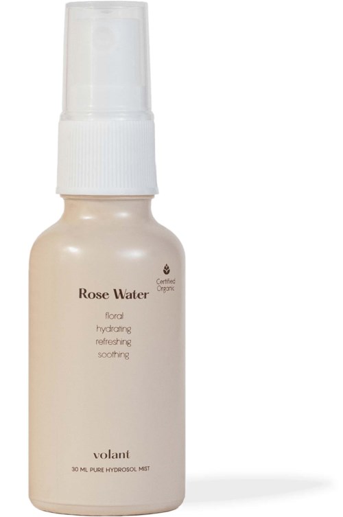 A white spray bottle labeled 'Rose Water' with a clear cap. It says it's for hydrating and soothing skin.
