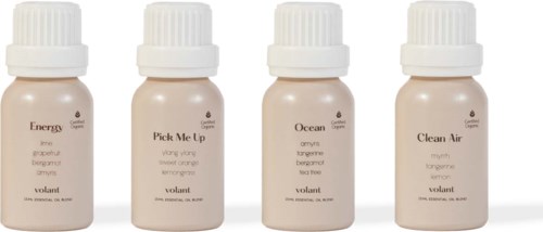 Four small bottles with white caps, labeled with different names: Energy, Pick Me Up, Ocean, Clean Air.