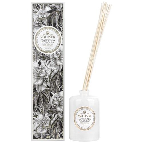 Geurende diffusor met bloemrijke zwart-wit verpakking en witte fles.