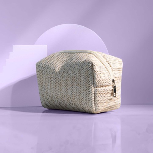 A beige textured bag with a zipper handle, placed on a purple background with geometric shapes.