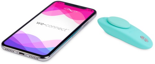 A smartphone with a colorful screen and a small blue device next to it.