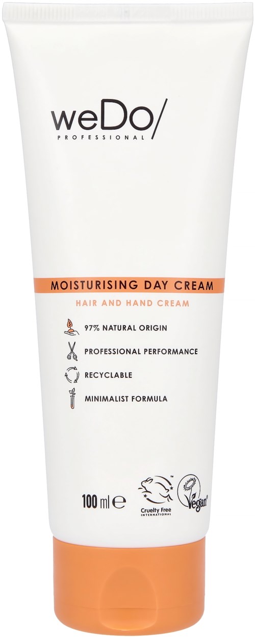 En vit tub med orange och svart text, märkt 'weDo PROFESSIONAL MOISTURISING DAY CREAM' för hår och händer.