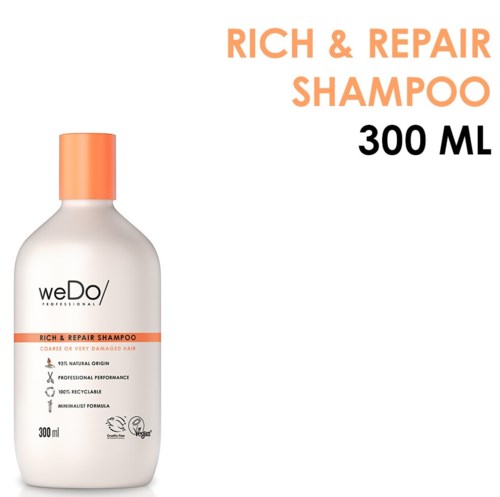 En hvit flaske med oransje hette merket WeDo Rich & Repair Shampoo, 300 ml, for skadet hår.