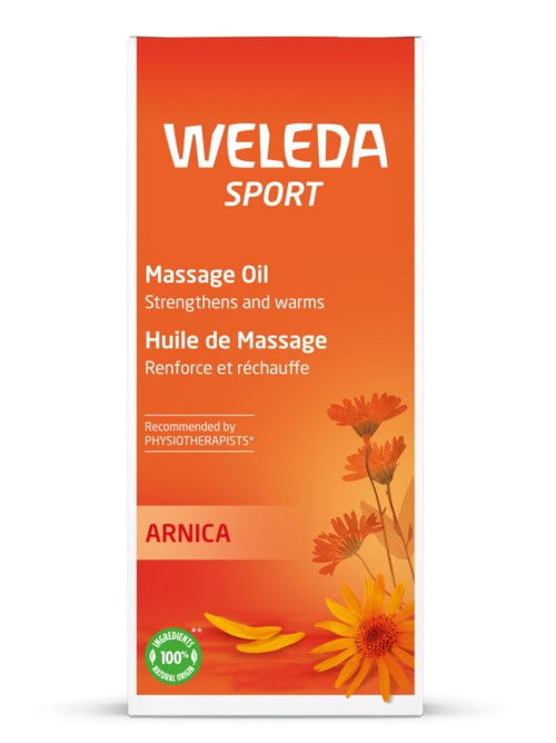 En ljus orange flaska med blommor och en bananbild, märkt Weleda Sport Massage Oil, för muskelvärmning och lindring.