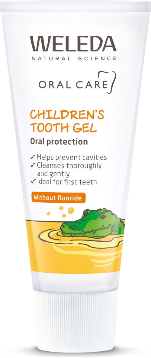 En tandkrämstub för barn med en krokodilillustration som visar att den är fri från fluoride och främjar rena, friska tänder.