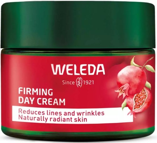 A green jar of Weleda firming day cream with a red label featuring a pomegranate and notes of reducing wrinkles.