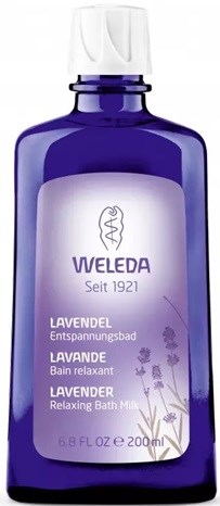 A blue bottle of Weleda lavender relaxing bath milk, with a white cap and lavender illustrations.