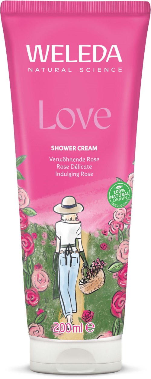 Pinkki puteli Weleda Love suihkavoidetta naisella ja ruusuilla, 200 ml.