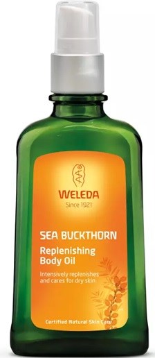 A green bottle with an orange label containing Weleda Sea Buckthorn Replenishing Body Oil.