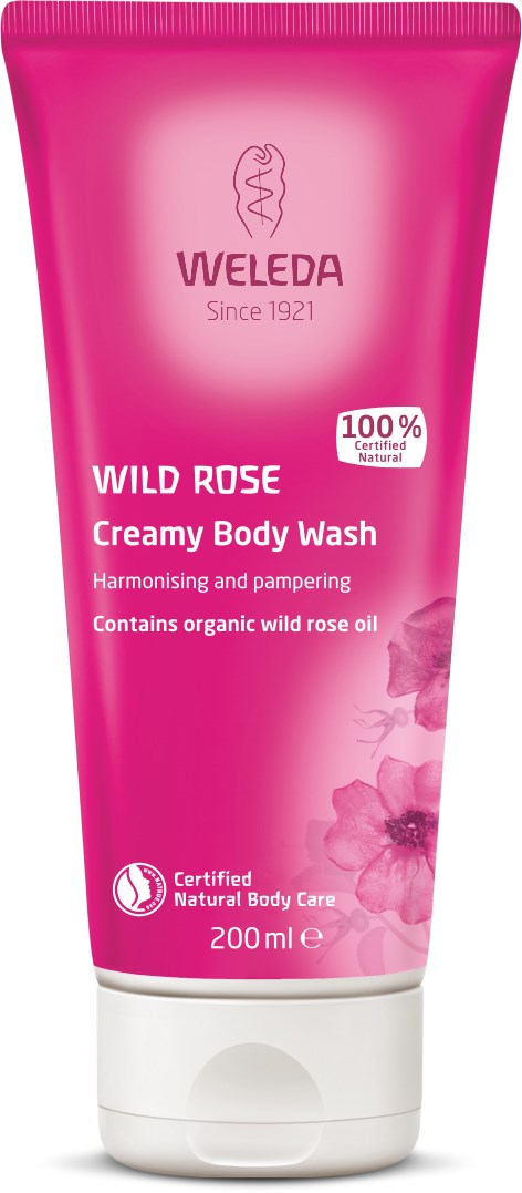 Rosa tub med Weleda Wild Rose Foamy Body Wash med rosbilder och text om naturliga ingredienser.