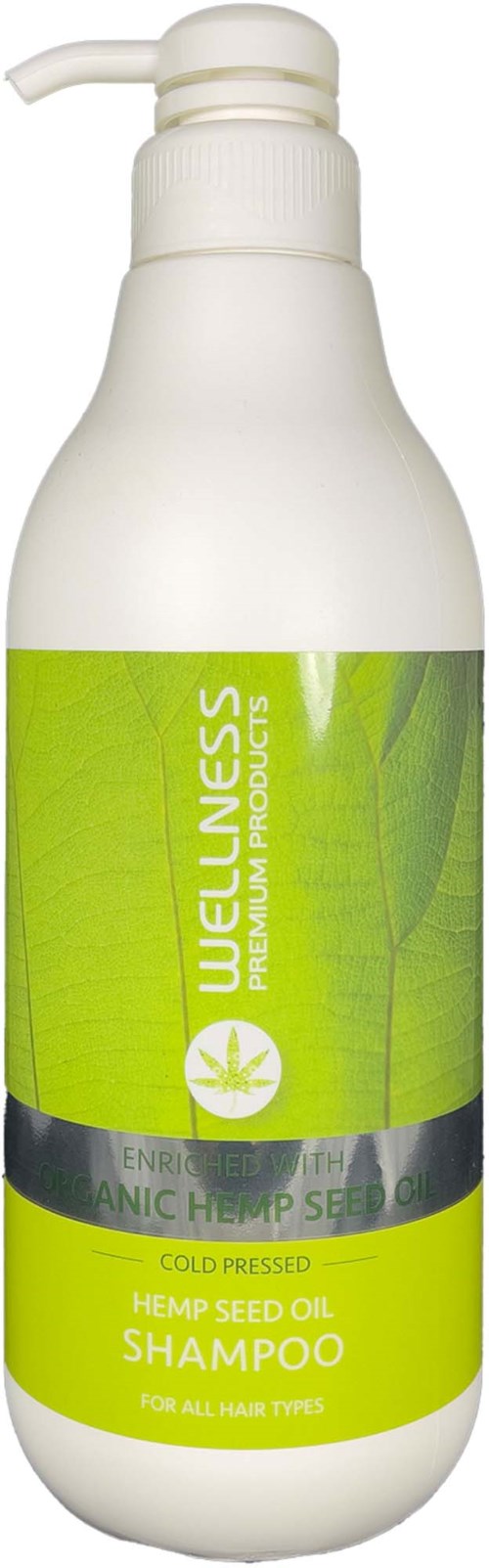 En vit flaska märkt Wellness Hemp Seed Oil Shampoo med en grön etikett och pumpdusch.
