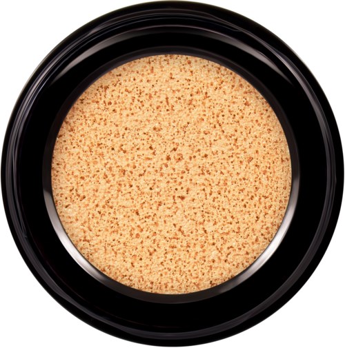 En rund beholder med beige, flekkete overflate, sannsynligvis et pulver i en svart krukke.